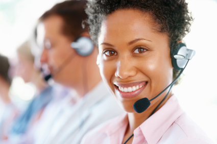Closeup of African American female executive in headset at office